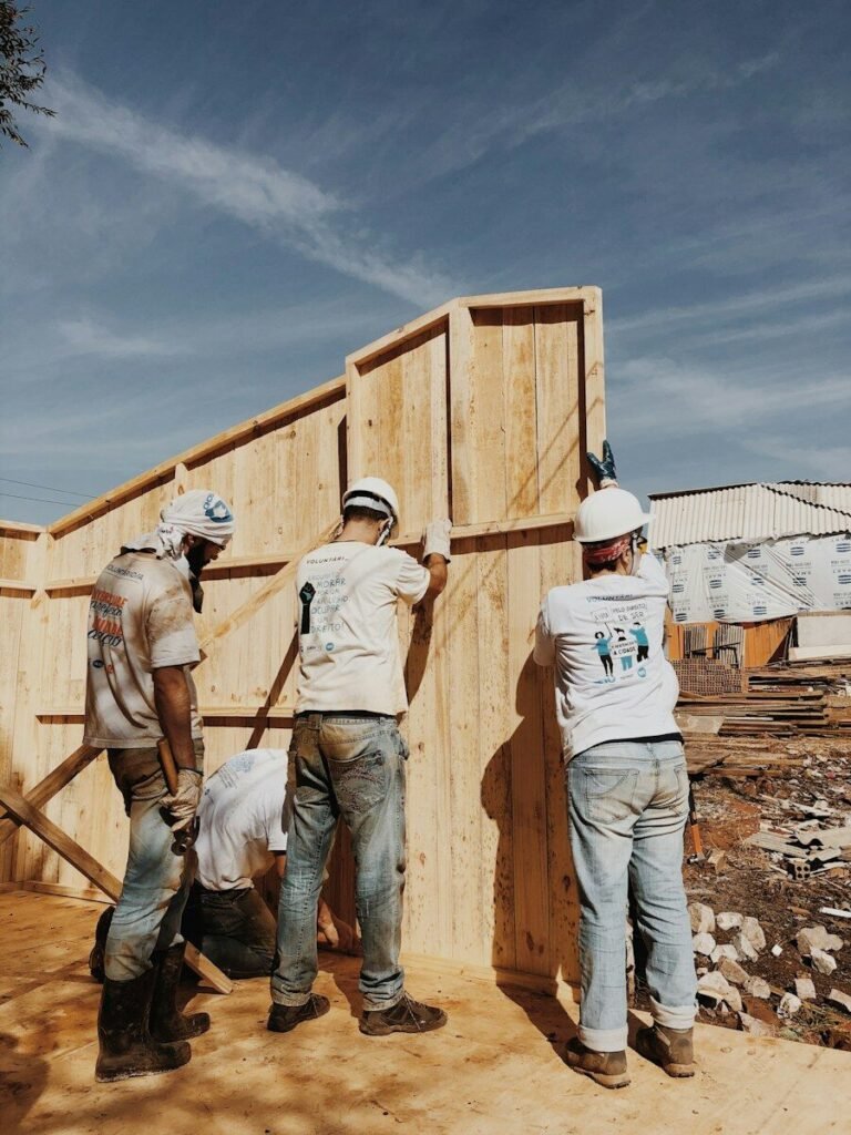 Summit Custom Homes crew raising a framed wall on a new home