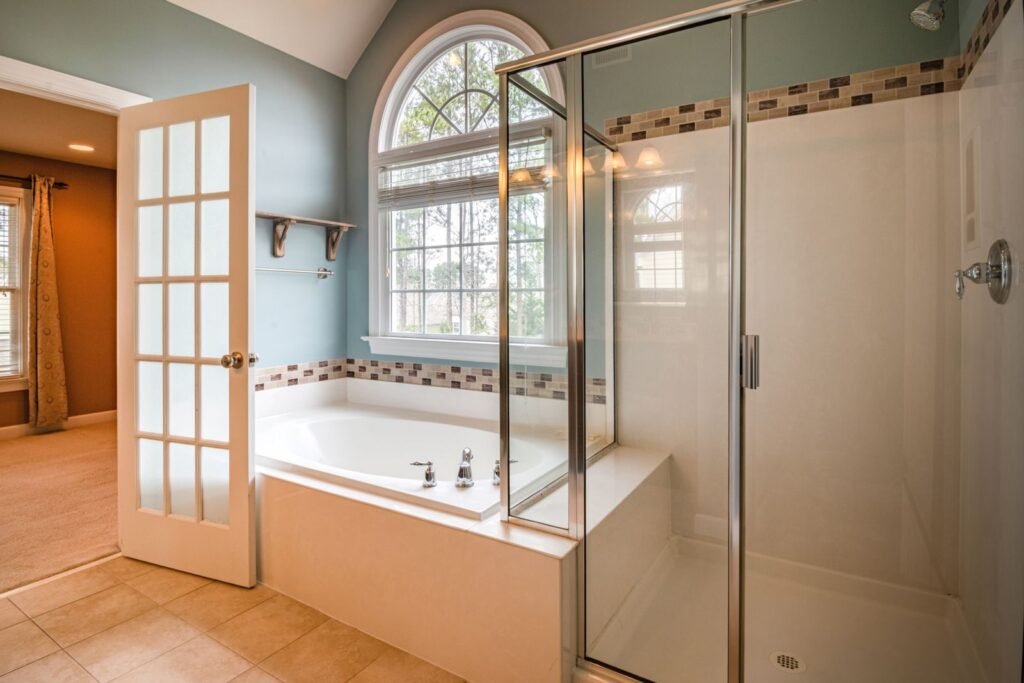 Primary bathroom with a soaking tub and glass shower