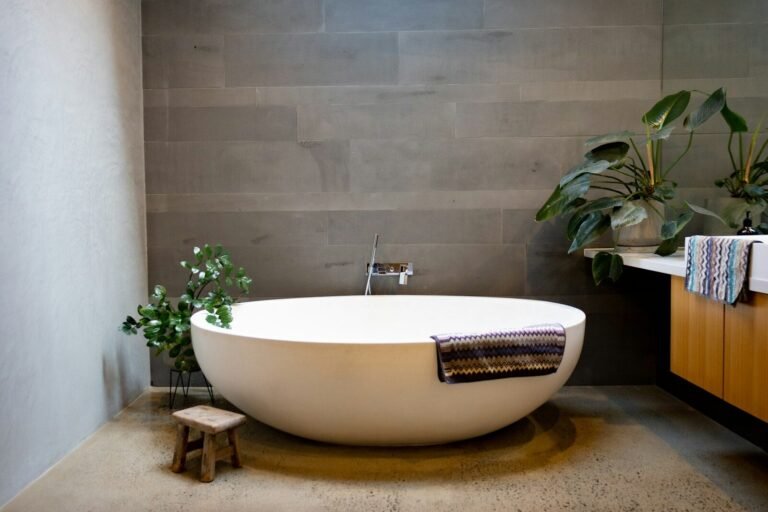 Spa-style bathroom with a soaking tub and gray tile walls