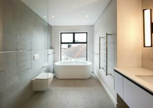Primary bathroom with a freestanding tub, glass shower and floating vanity
