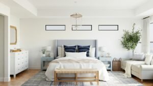 Bright primary bedroom with an upholstered bed and natural light