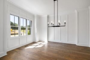 Dining room with a black chandelier and tall windows