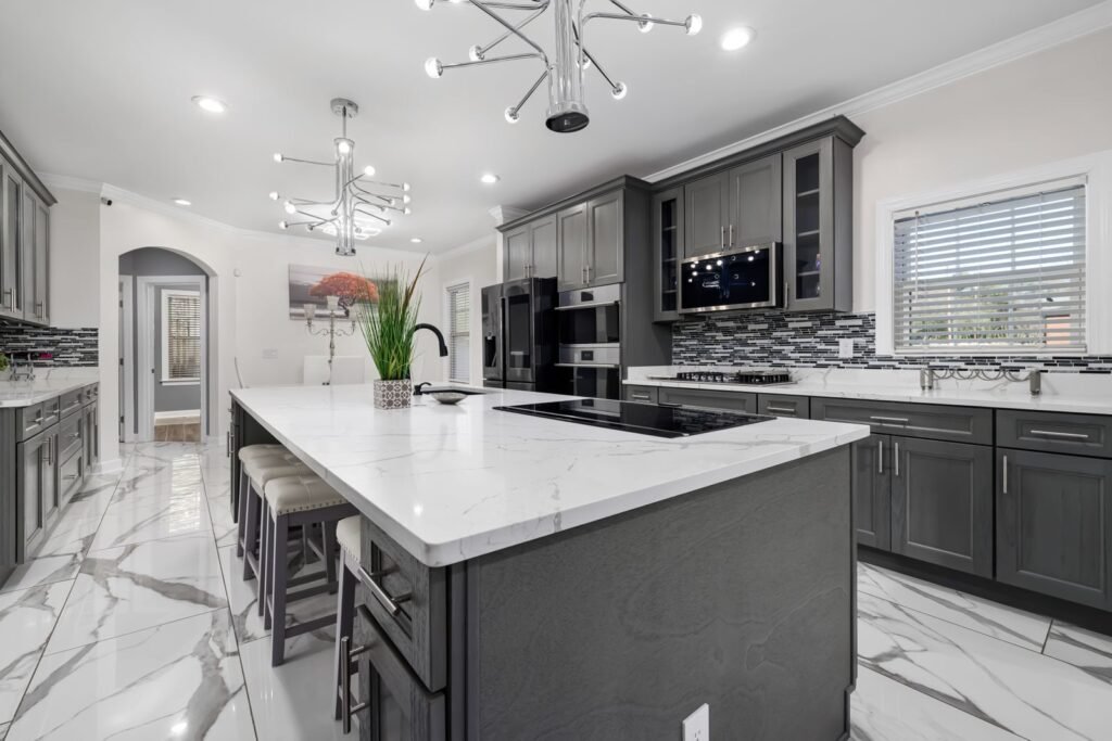 Kitchen with gray cabinets and a white island
