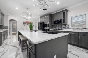 Kitchen with gray cabinets and a white island
