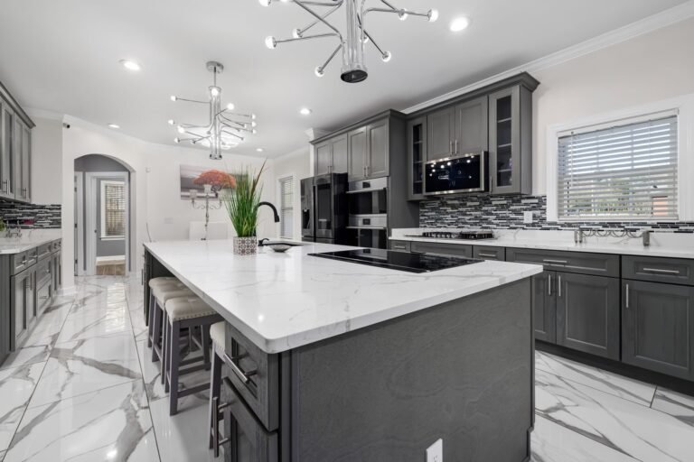 Kitchen with gray cabinets and a white island
