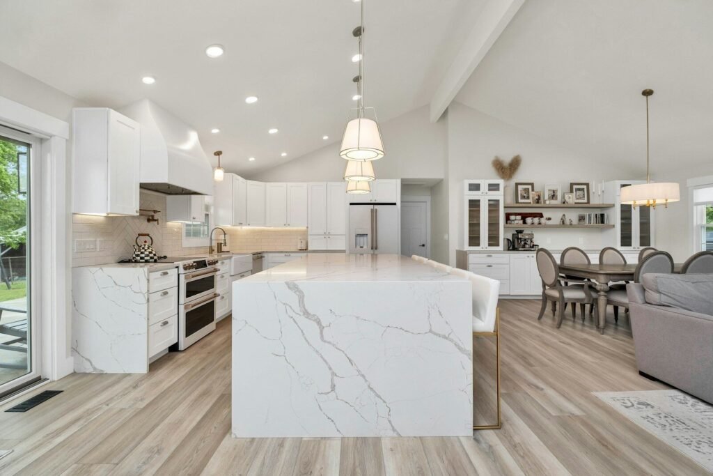 Open-concept kitchen with a marble island flowing into the dining area