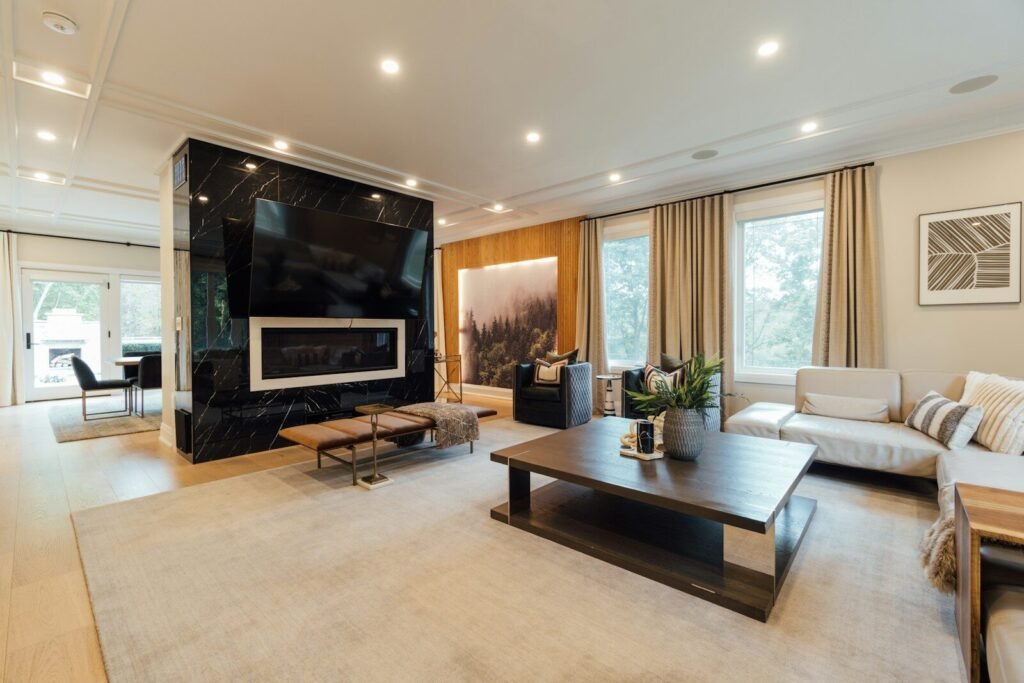Open living room with a black marble fireplace wall