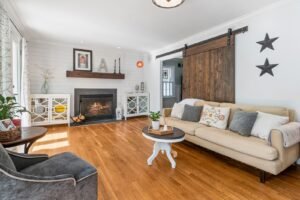Living room with a brick fireplace and sliding barn door