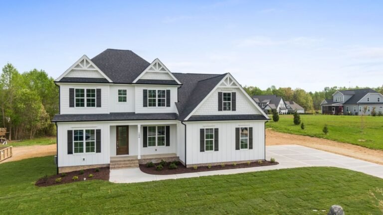 The Summit Ridge: white modern farmhouse with black windows, front view